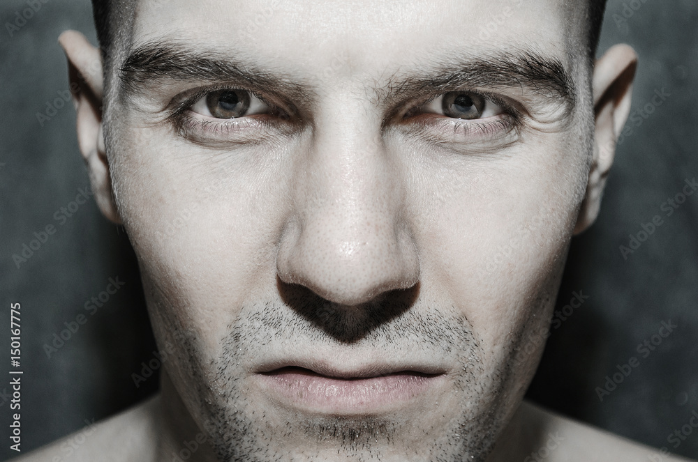 Portrait of a European male close-up with bristles on a gray background Portrait of a European male close-up with bristles on a gray background