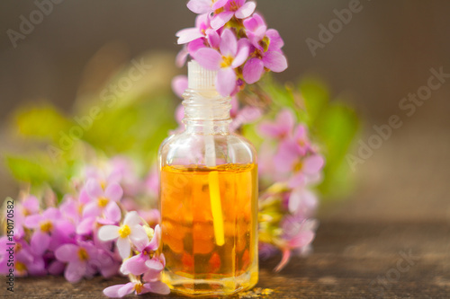 Essential oil of Arabis flower on a table in beautiful bottle