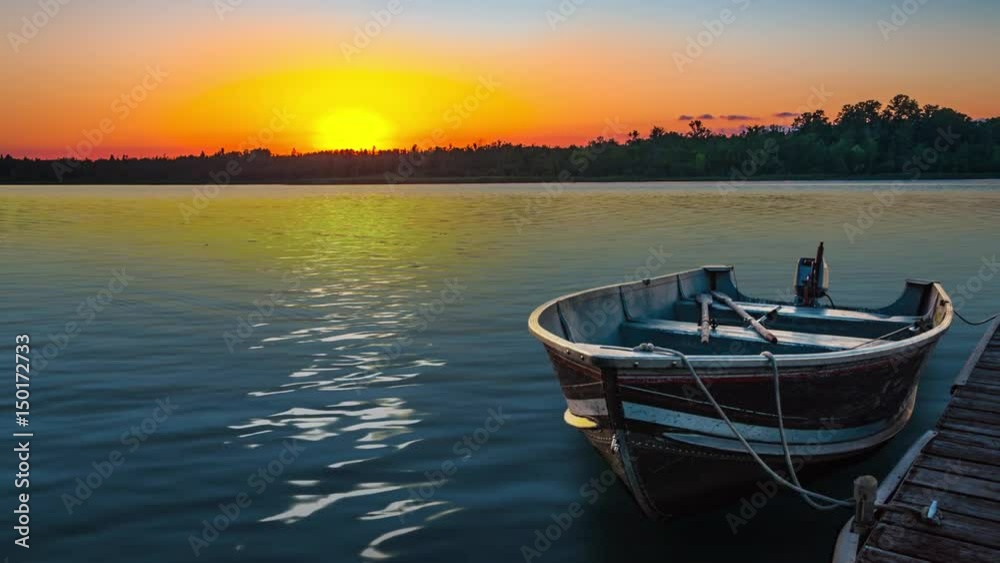 fishing boat on tranquil lake at sunset in Minnesota fishing boat on tranquil lake at sunset in Minnesota