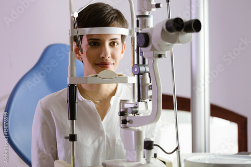 Woman doing eye test with optometrist in medical center