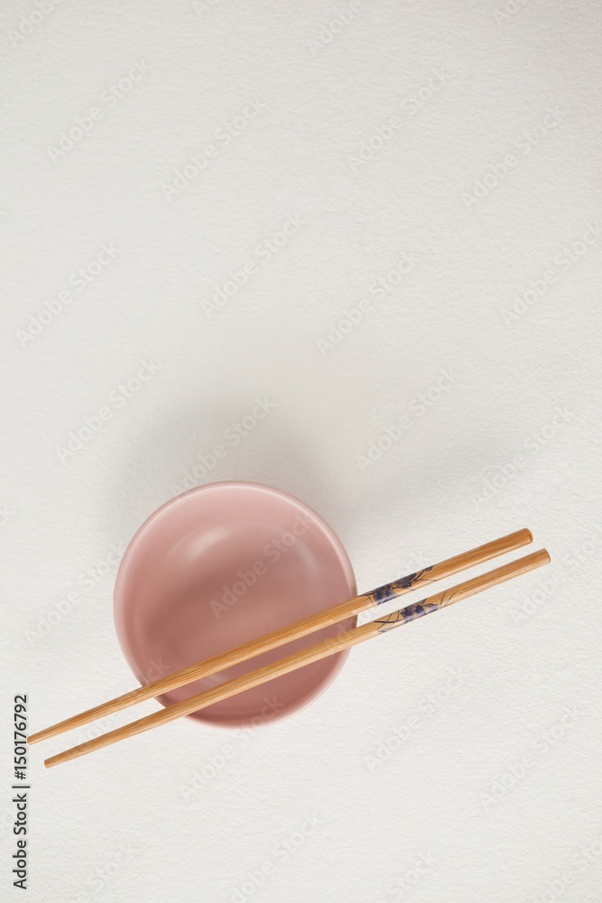Pair of chopsticks over a bowl Pair of chopsticks over a bowl