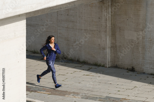 Female urban athlete running outdoor.