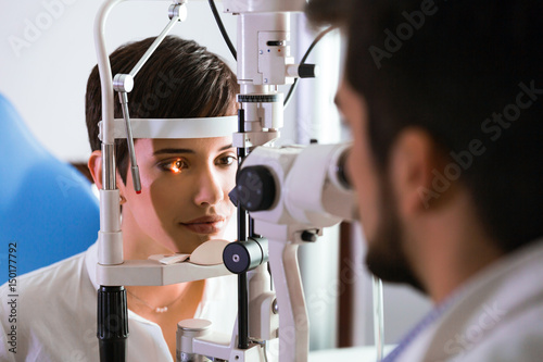 optometrist checking patient eyesight and vision correction