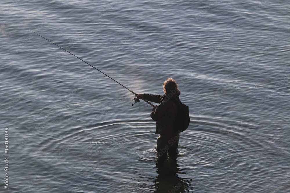Angler wirft die Spinnrute aus an der Ostsee Angler wirft die Spinnrute aus an der Ostsee