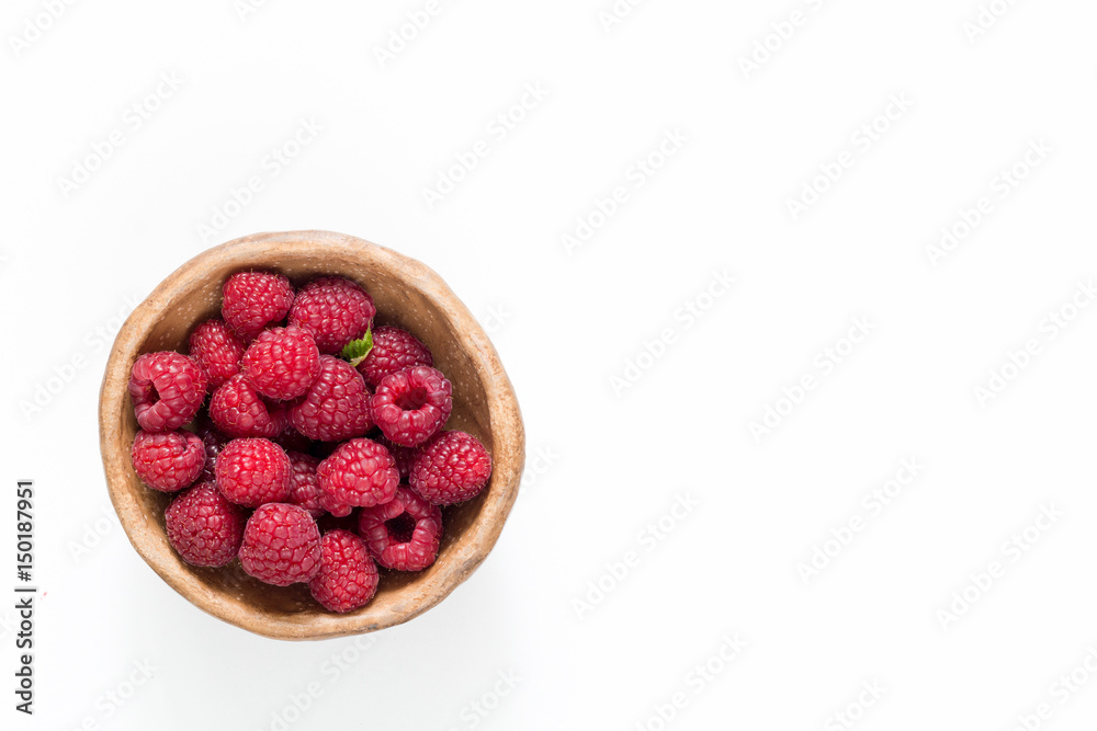 Raspberries in bowl isolated on white, top view Raspberries in bowl isolated on white, top view