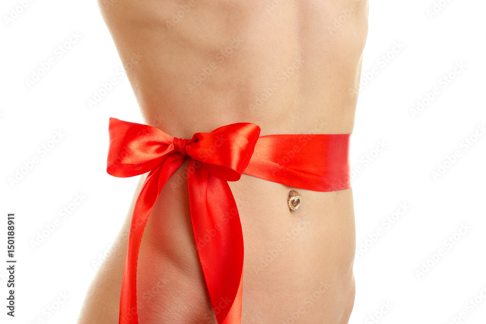 beautiful young girl's belly with a Red Ribbon is isolated on a white background beautiful young girl's belly with a Red Ribbon is isolated on a white background