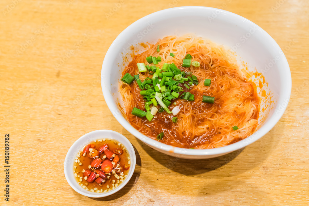 Teowchew Fishball noodles with soup and chili sauce on table Teowchew Fishball noodles with soup and chili sauce on table