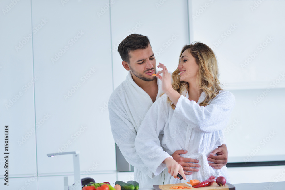 Happy couple cooking breakfast together in the kitchen Happy couple cooking breakfast together in the kitchen