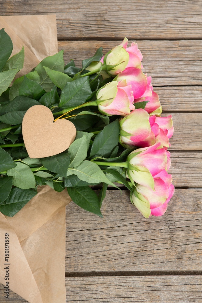 Bunch of pink roses with heart shape tag