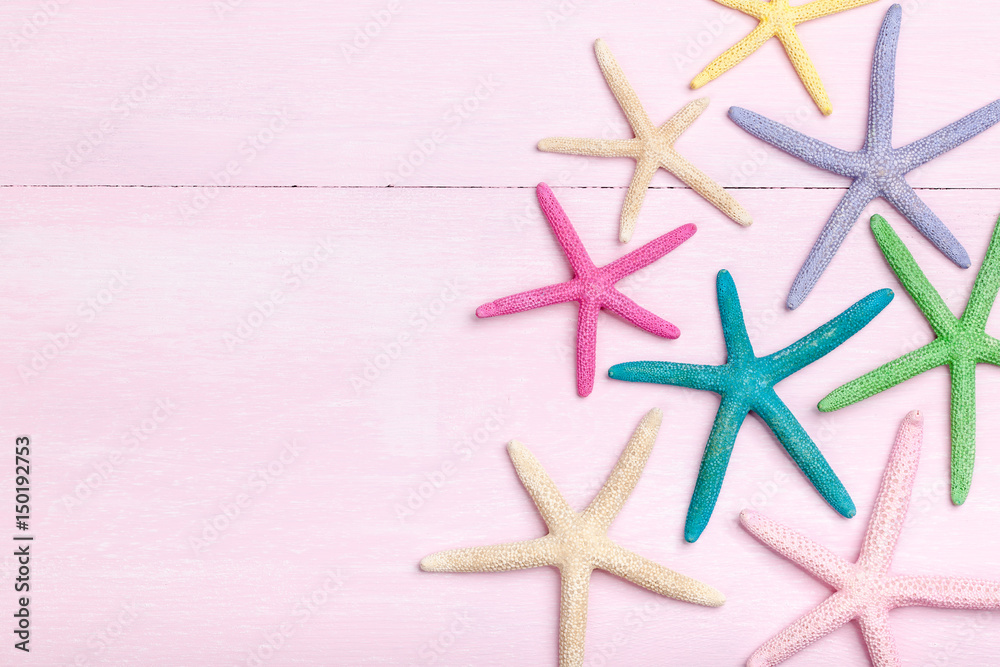 Colorful starfishes on pink wooden background Colorful starfishes on pink wooden background