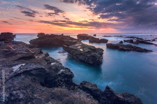 breathtaking cloudy sunset during low tide at mengening beach, Bali