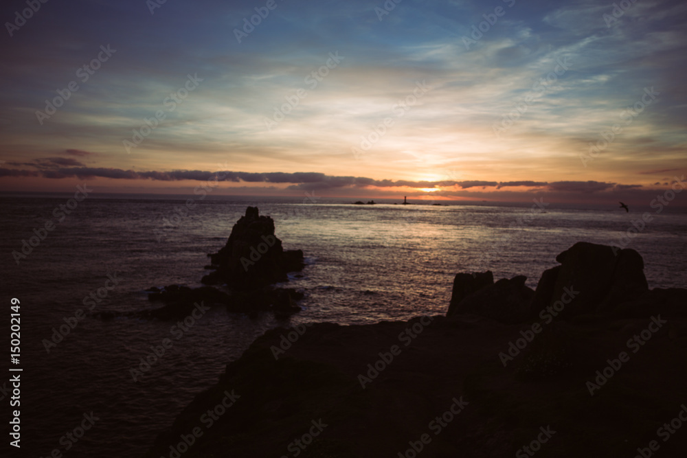 Sunset at lands end in Cornwall with clouds