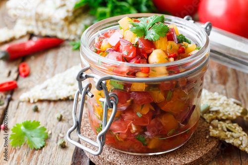 Tomato salsa with chili in a glass jar
