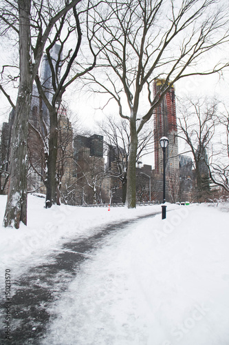 Walkway on snow at Central Park and buildings in Manhattan