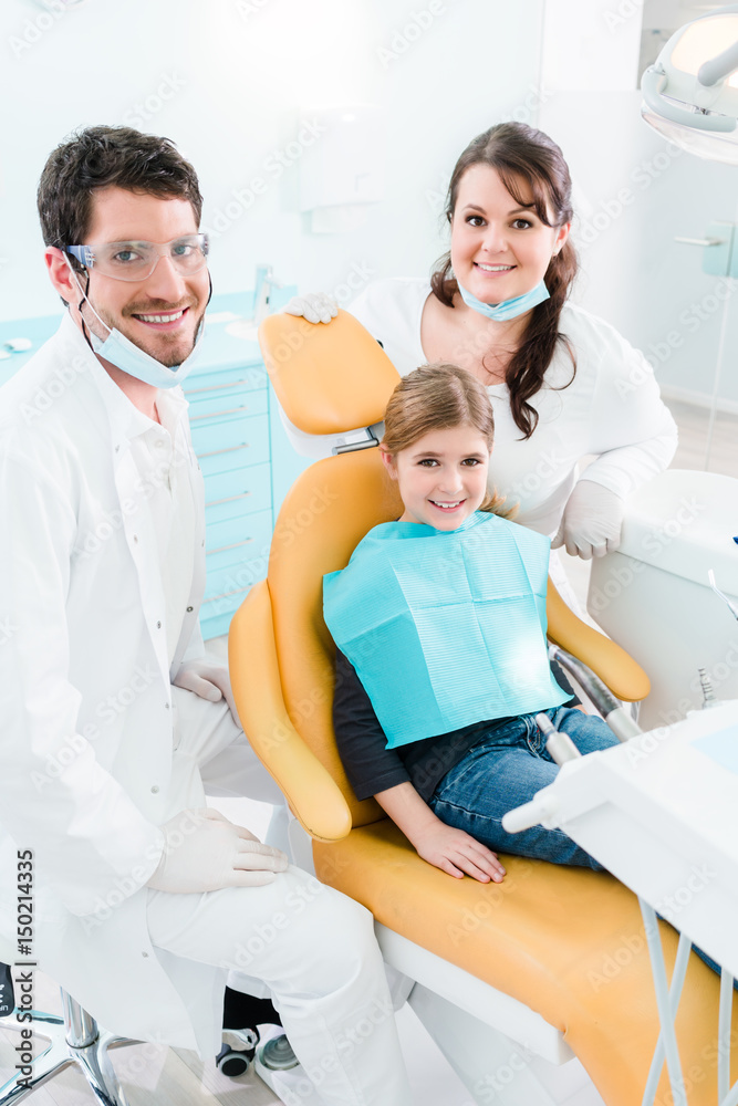 Dentist treating child in his surgery Dentist treating child in his surgery