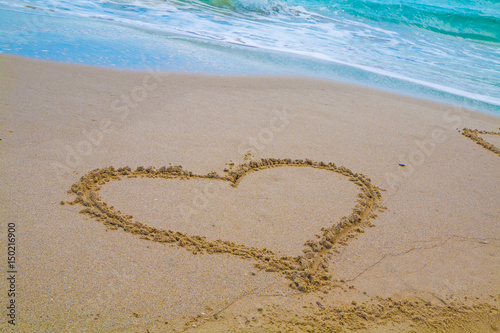 Heart drawn in the sand. Beach background. Top view. Sardinia  Italy