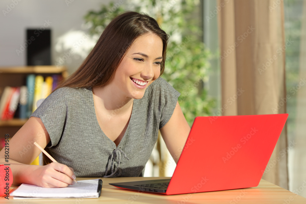 Student taking notes and learning with a laptop Student taking notes and learning with a laptop