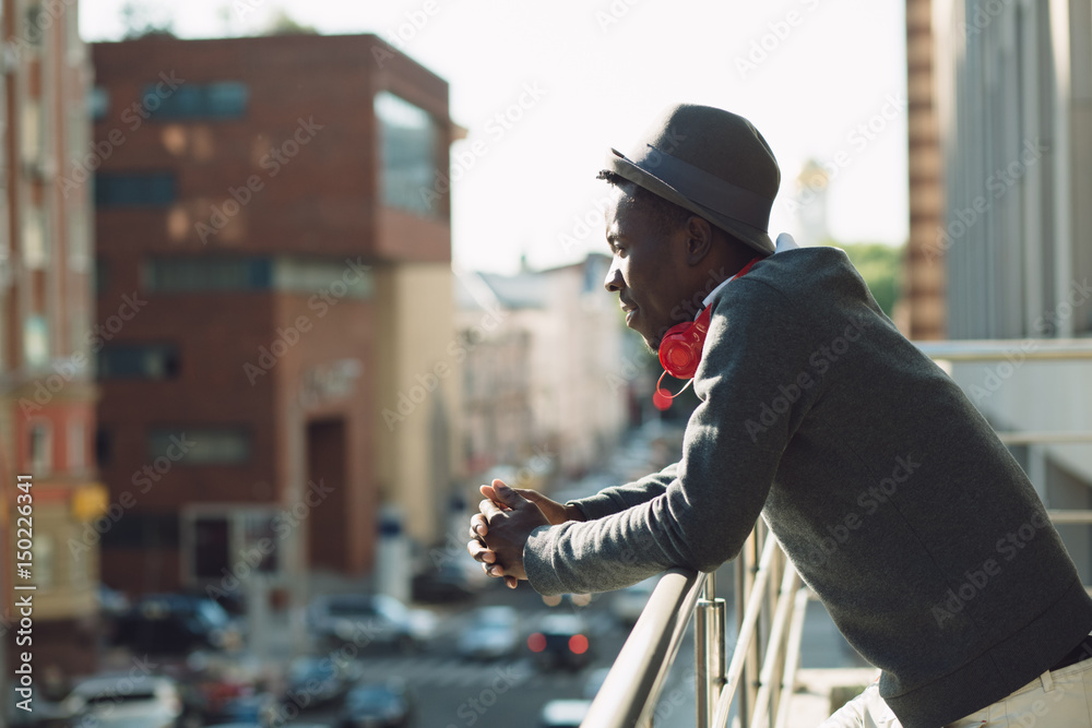 African american man with headphones looking at city