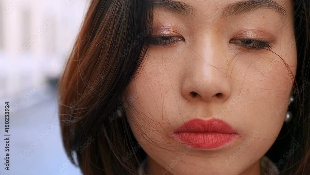 Close up of serious cute Asian woman's face - outdoor Close up of serious cute Asian woman's face - outdoor