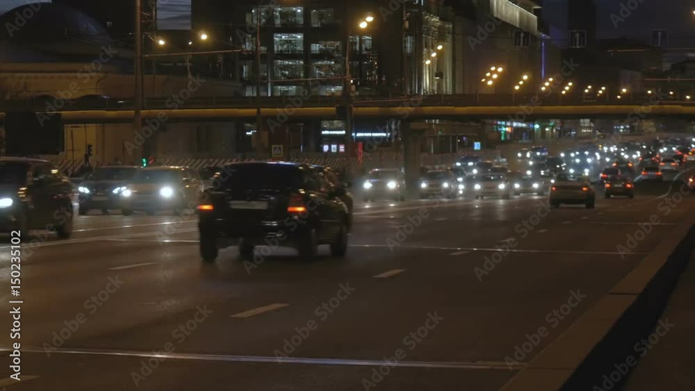 Timelapse. Very intense traffic on the streets of the city. In evening time. One road passes under the other.