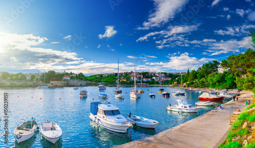 Wonderful romantic summer evening landscape panorama coastline Adriatic sea. Boats and yachts in harbor at cristal clear azure water. Old town of Krk on the island of Krk. Croatia. Europe.