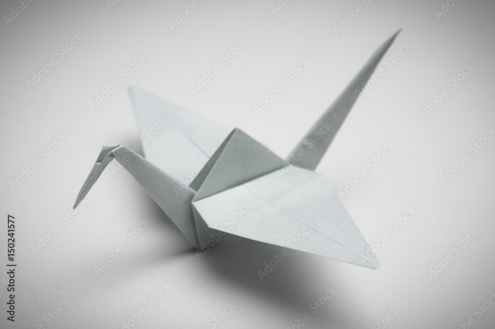 White Crane. Folded paper craft origami bird. Symbol of peace, luck and happiness - obrazy, fototapety, plakaty 