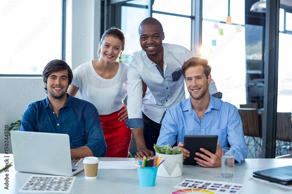 Team of graphic designers smiling while working together Team of graphic designers smiling while working together
