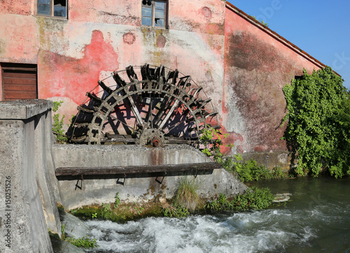 big wheel of an old abandoned water mill