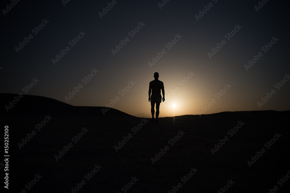 walking man silhouette at sunset sky