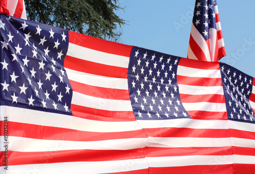 Series of American flags with blue sky