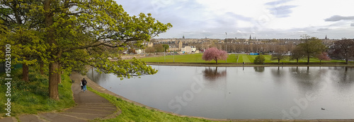 Panoramic romantic view, walking couple at Inverleith Park, Edinburgh, Scotland