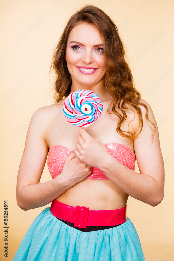 Woman holding colorful lollipop candy in hand. Woman holding colorful lollipop candy in hand.