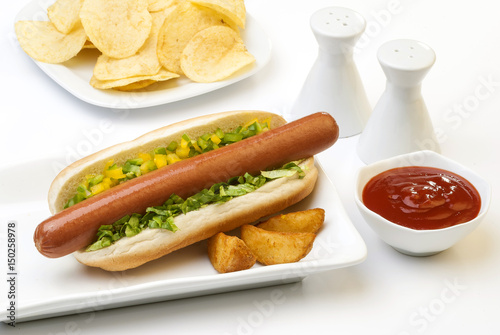 Chicken Jumbo Hotdog sandwich with fries & Ketchup on white plate 