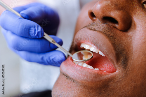 African male patient getting dental treatment in dental clinic