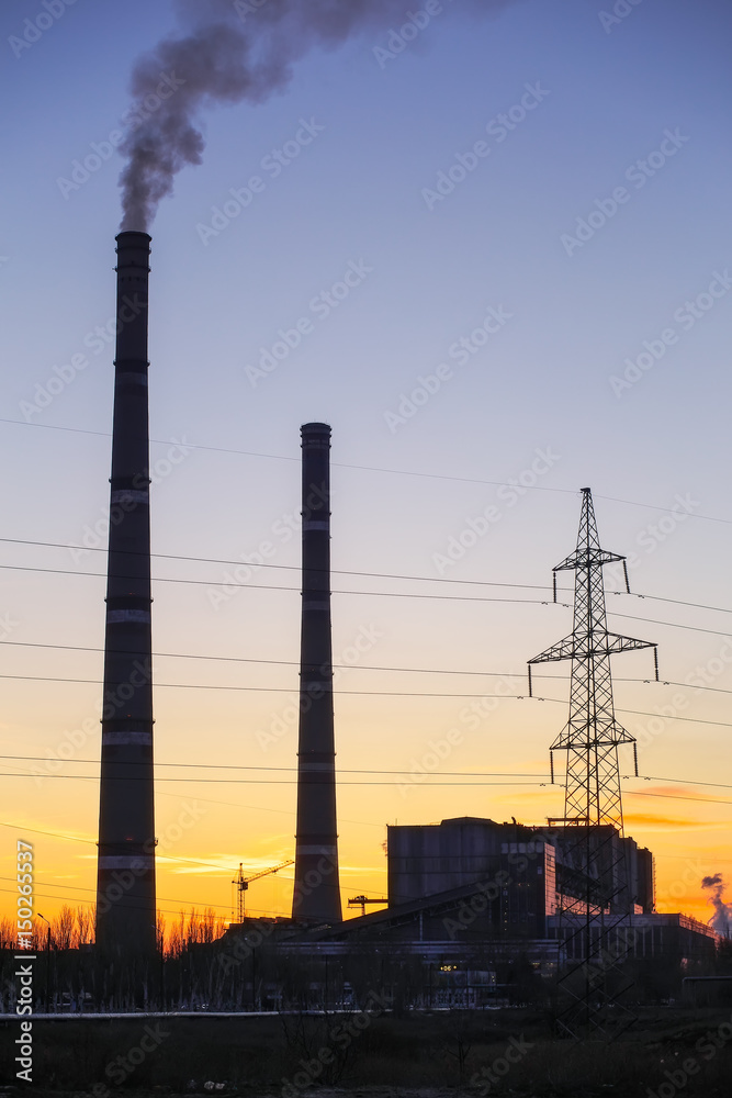 Thermal power plant and sunset fiery sky.