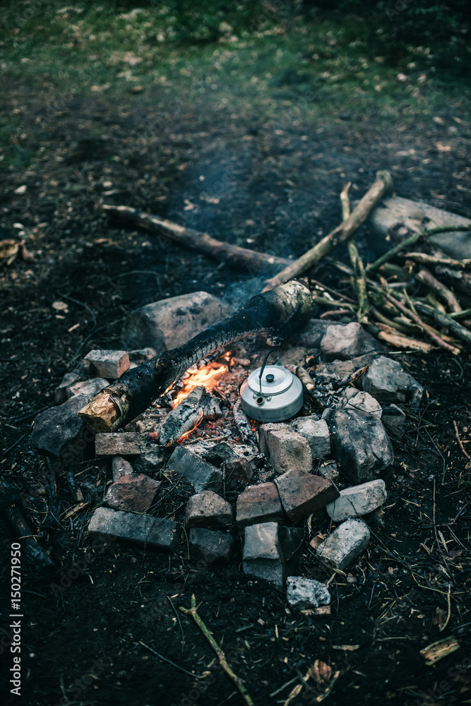 Fototapeta premium Metal kettle boiling water on a campfire.