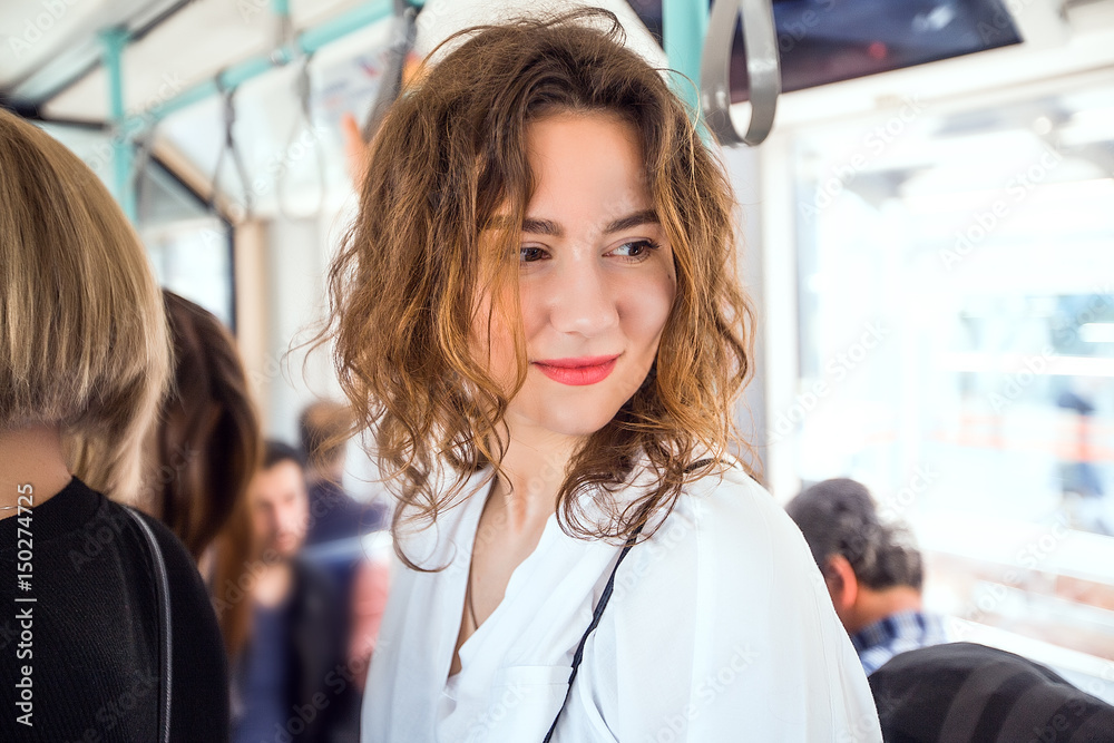 Fototapeta premium Young woman standing in a metro