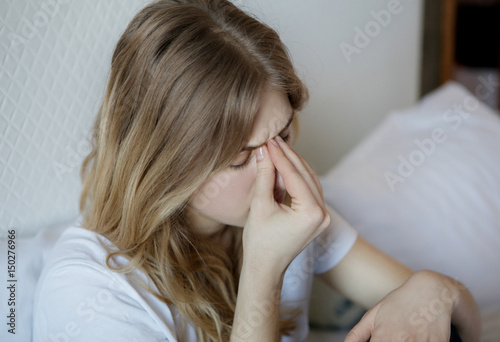 Young sick woman with sinus pain. photo