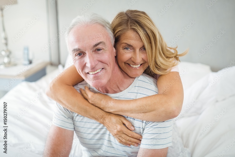 Portrait of happy senior couple embracing each other on bed Portrait of happy senior couple embracing each other on bed