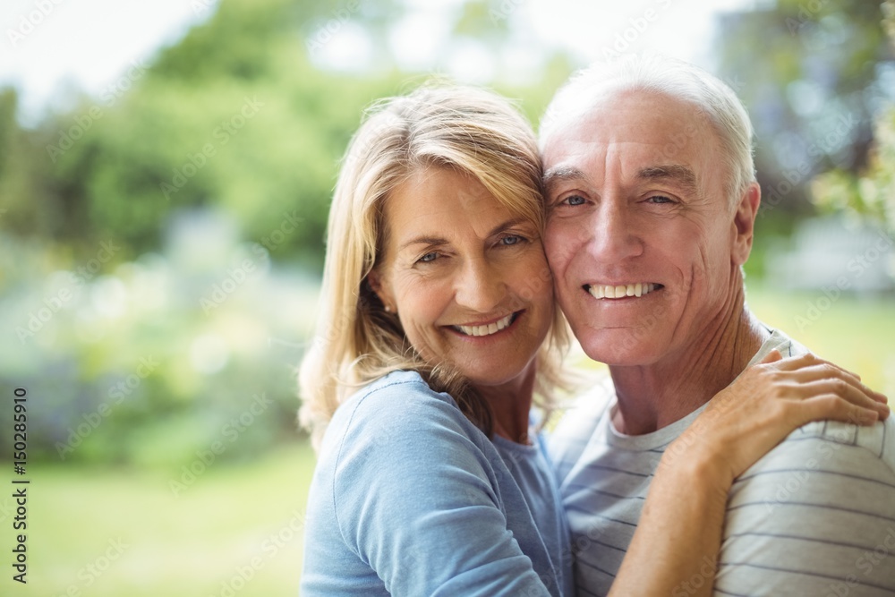 Portrait of senior couple embracing outdoors Portrait of senior couple embracing outdoors