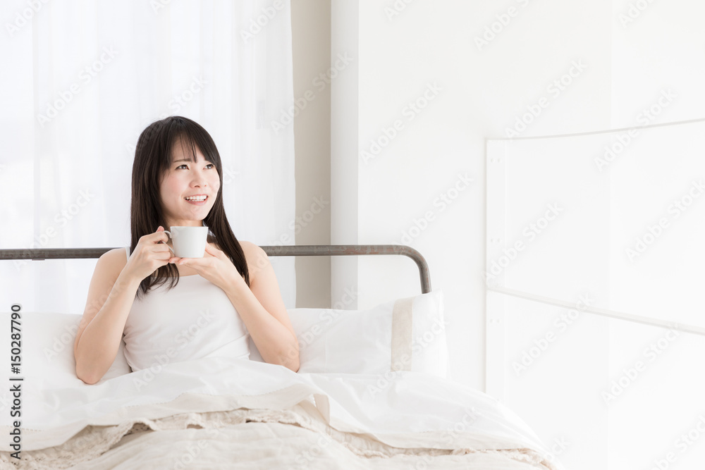 attractive asian woman relaxing in bedroom attractive asian woman relaxing in bedroom