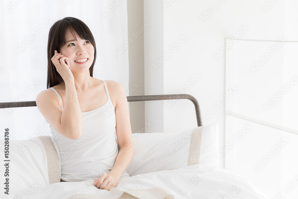 attractive asian woman relaxing in bedroom attractive asian woman relaxing in bedroom