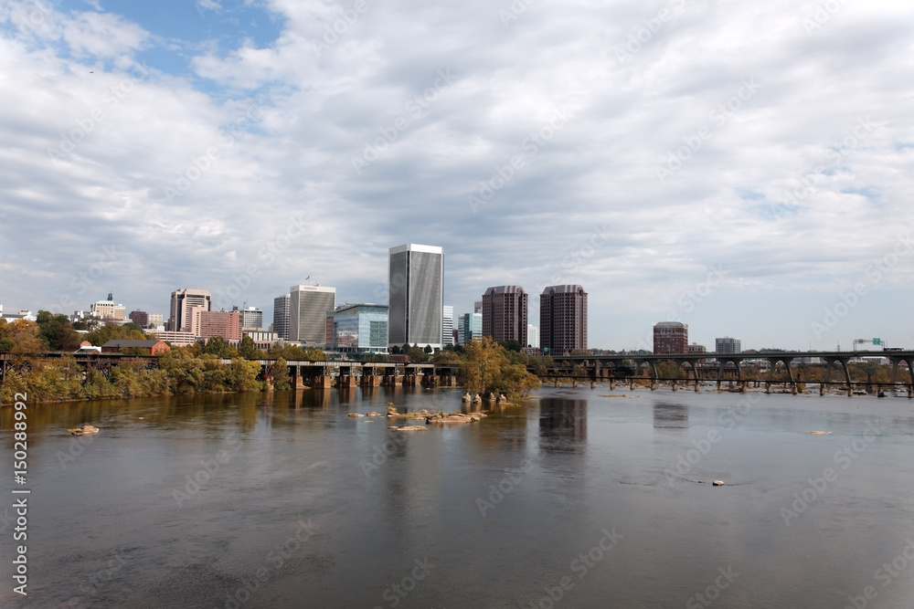 Richmond, Virginia skyline with the James River in foreground.
