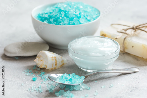 spa composition with blue sea salt and natural soap on stone desk background