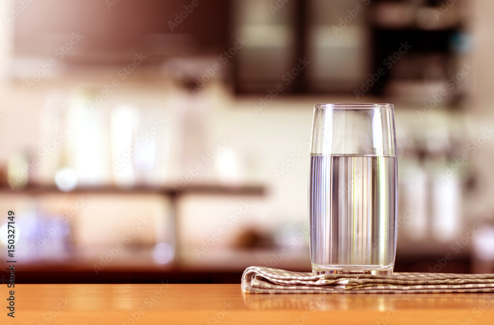 the Glass of purified water on the table bar in kitchenroom