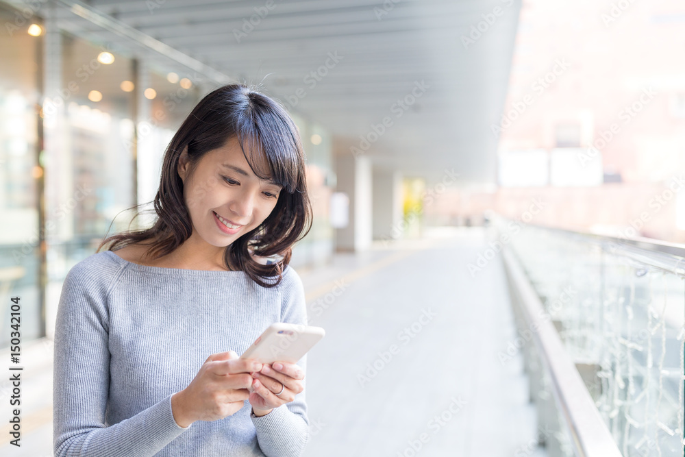 Woman sending sms on cellphone Woman sending sms on cellphone