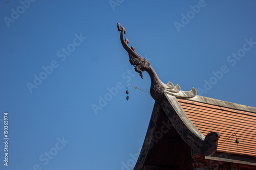 Thai temple roof top with blue sky background