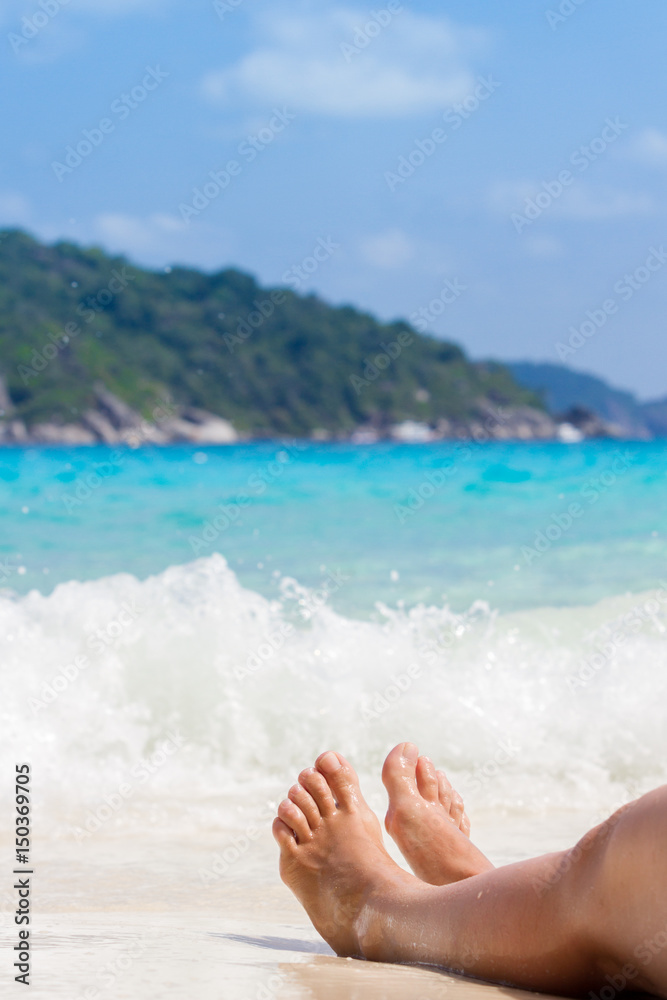 Female legs on the backdrop of the Andaman sea. Holidays, vacation Female legs on the backdrop of the Andaman sea. Holidays, vacation