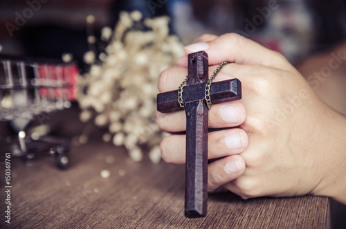 wooden cross in the hand with focus on the cross