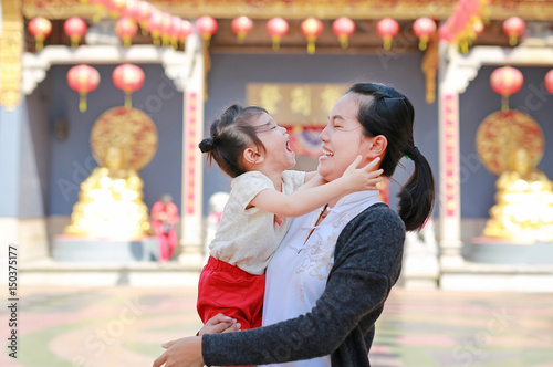Photography portrait of mother and cute little girl in Yaowarat Road (Bangkok chinatown) at Chinese new year, Bangkok Thailand
